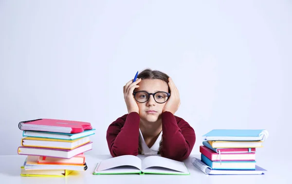 Teenage girl with pile of books — Stock Photo, Image