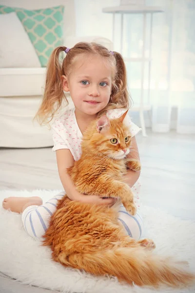 Cute little girl with red cat — Stock Photo, Image