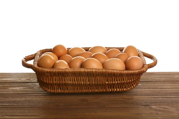 Basket with eggs on wooden table — Stock Photo, Image