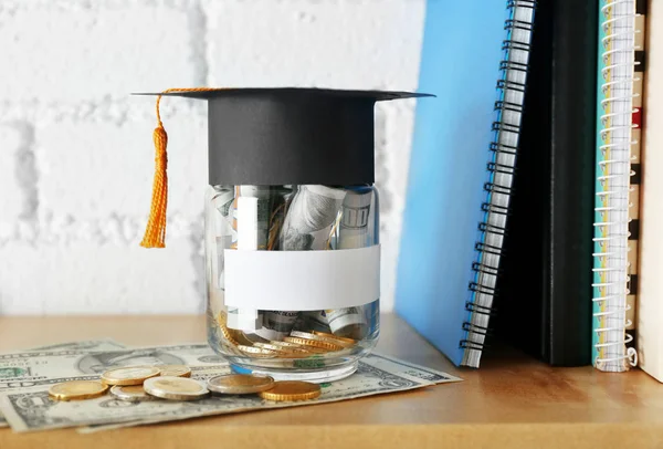 Glass jar with money for education and  books — Stock Photo, Image