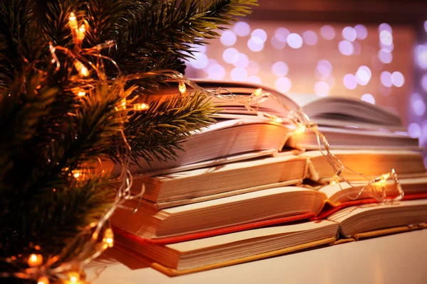 Pile of open books and garland — Stock Photo, Image