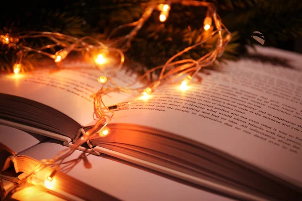 Pile of open books and garland — Stock Photo, Image