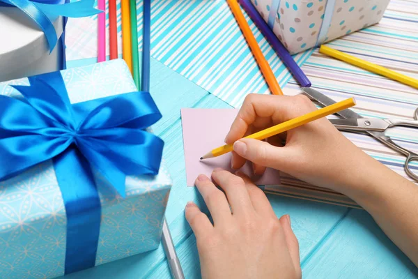 Hands of woman packing presents — Stock Photo, Image