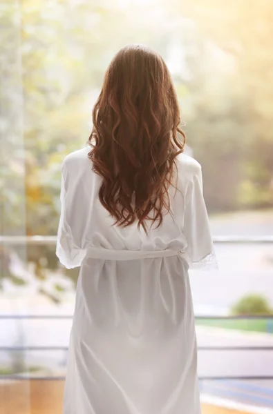 Beautiful woman in white silk robe — Stock Photo, Image