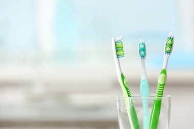 colorful Toothbrushes in glass clipart