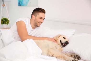 Labrador retriever ile yatan adam