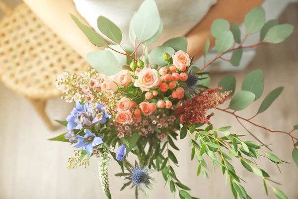 Female hands holding bouquet — Stock Photo, Image