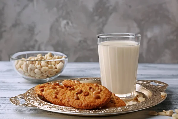 Peanut cookies with milk on tray — Stock Photo, Image