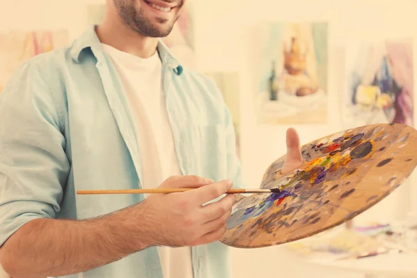 Young male artist painting — Stock Photo, Image