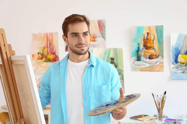 Young male artist painting