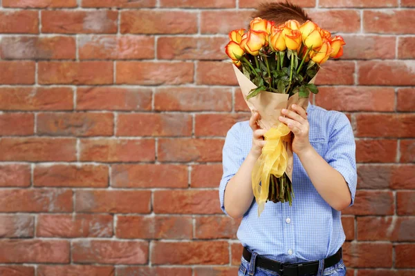 Boy with bouquet of beautiful flowers — Stock Photo, Image