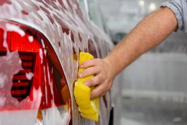 Male hand with sponge cleaning car — Stock Photo, Image