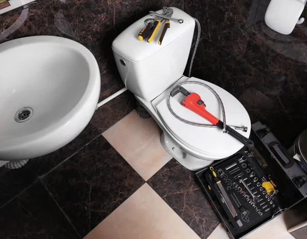 Loodgieter de tools op toilet — Stockfoto