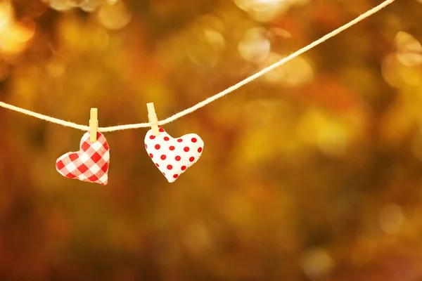 Hearts hanging on clothes pins — Stock Photo, Image