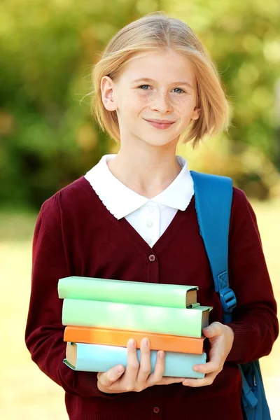 Colegiala con libros y bolsa —  Fotos de Stock