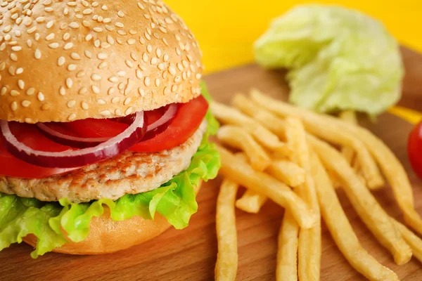 Tasty burger on cutting board — Stock Photo, Image