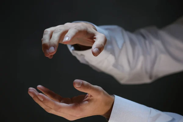 Businessman hands on dark background — Stock Photo, Image