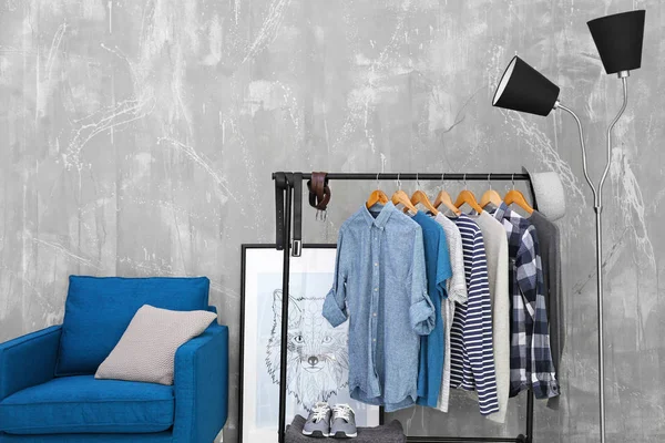 Casual stylish male shirts on hanger stand in room — Stock Photo, Image