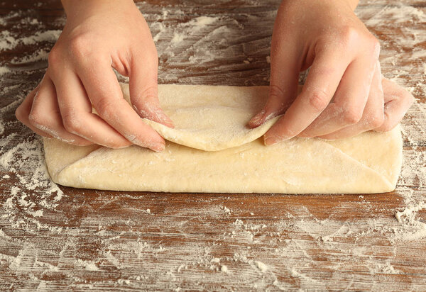 making envelope from rolled out dough 