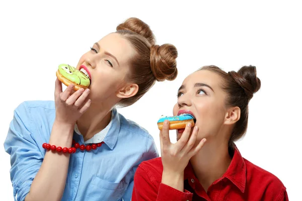 Women eating tasty donuts — 图库照片