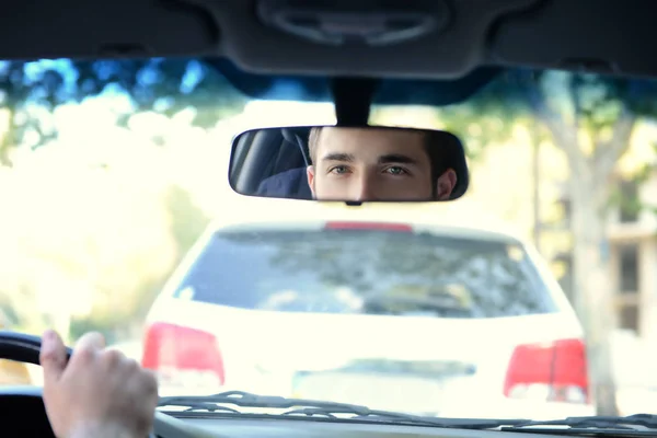 Driver looking in rear view mirror — Stock Photo, Image