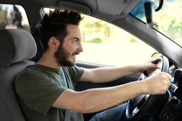 Young man driving car — Stock Photo, Image