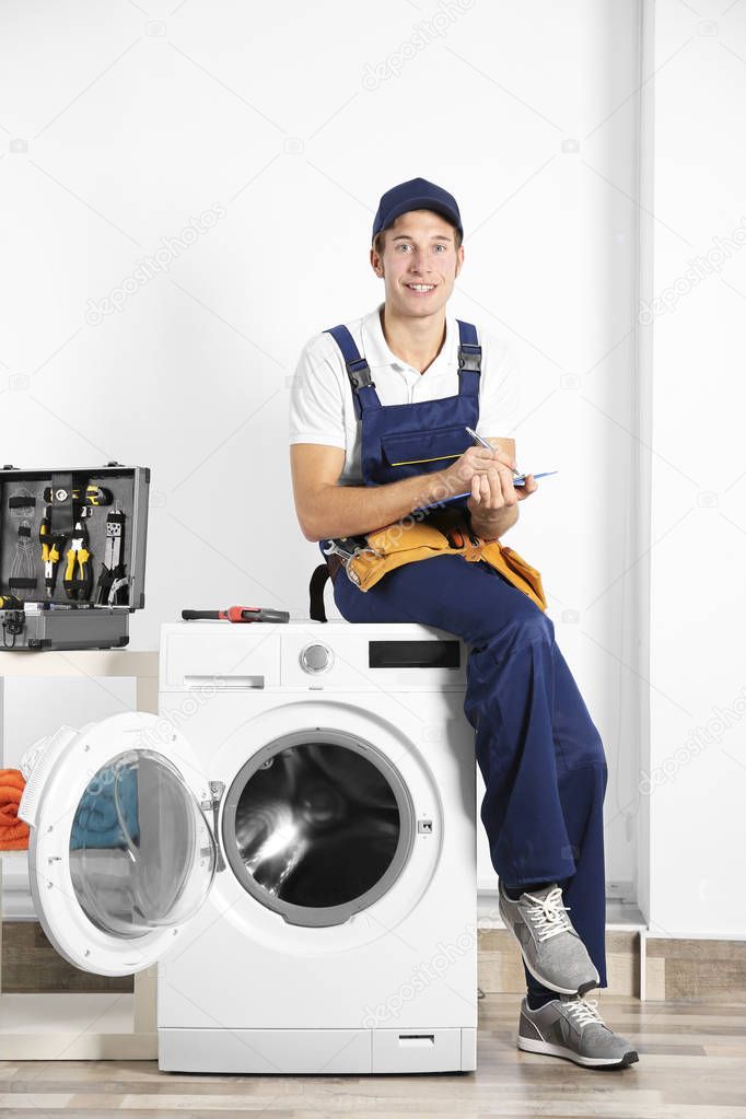 Plumber sitting on washing machine