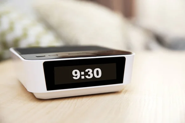 Digital clock on bedside table — Stock Photo, Image