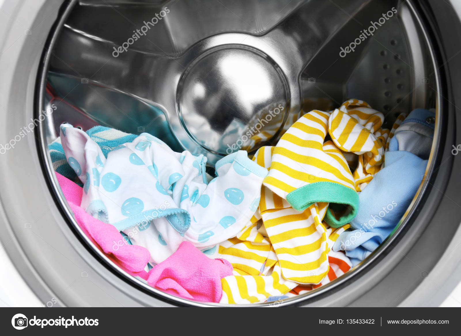 Clothes in washing machine Stock Photo by ©belchonock 135433422