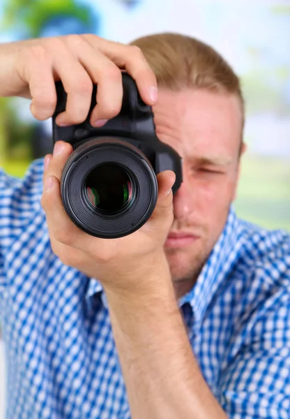 Handsome photographer with camera — Stock Photo, Image