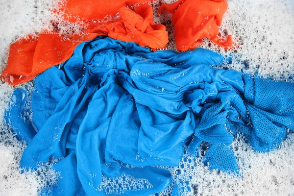 Wet color clothes with foam — Stock Photo, Image