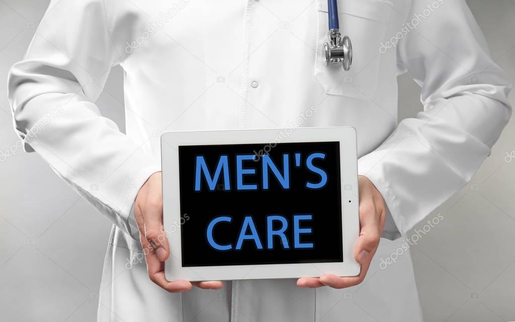 Doctor holding tablet with text MEN'S CARE 