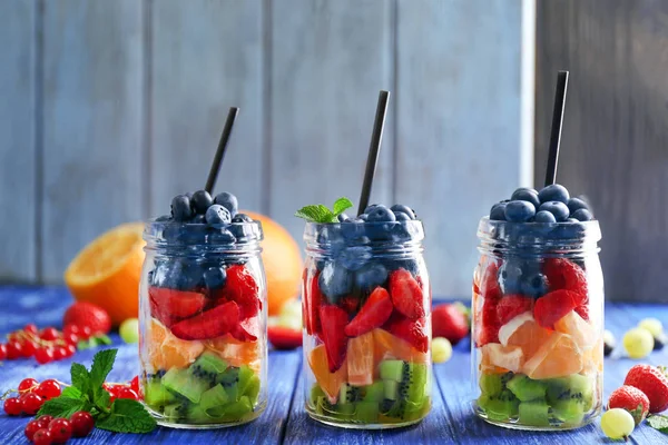 Jars with fruits and berries — Stock Photo, Image