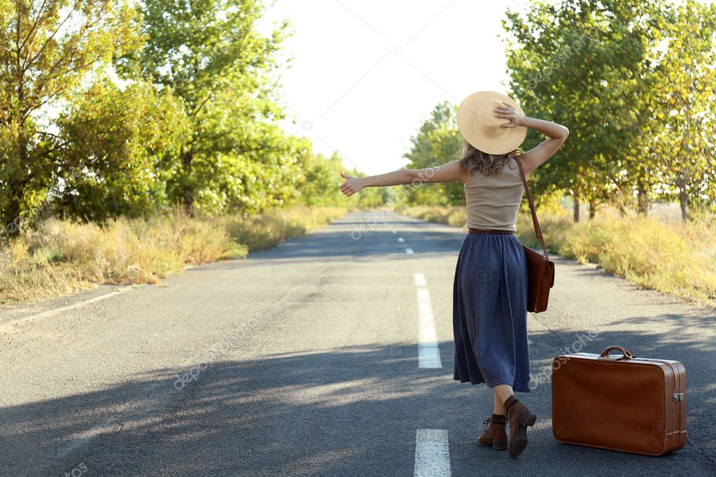 Young woman hitchhiking  