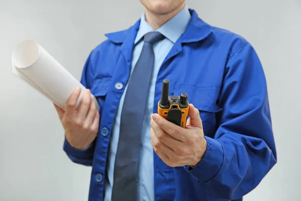 Engineer with drawing and radio transmitter — Stock Photo, Image