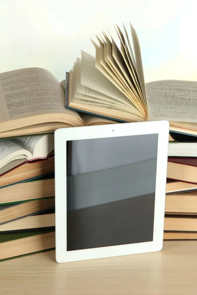 Tablet and pile of books — Stock Photo, Image