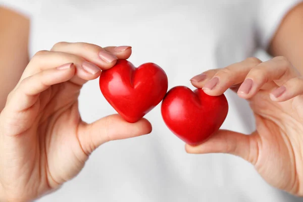 Woman holding red hearts — Stock Photo, Image