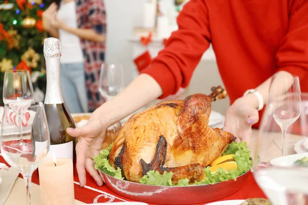Woman serving turkey for Christmas dinner