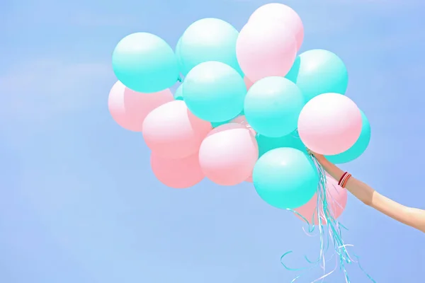 Hand holding colorful balloons — Stock Photo, Image