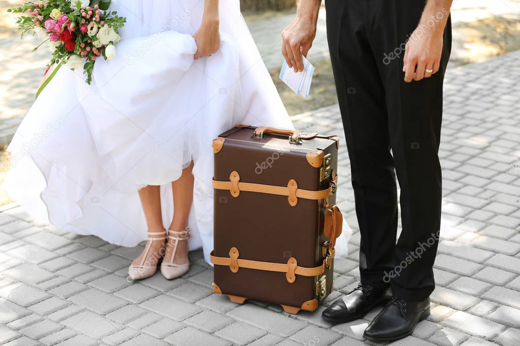 Groom and bride with vintage suitcase