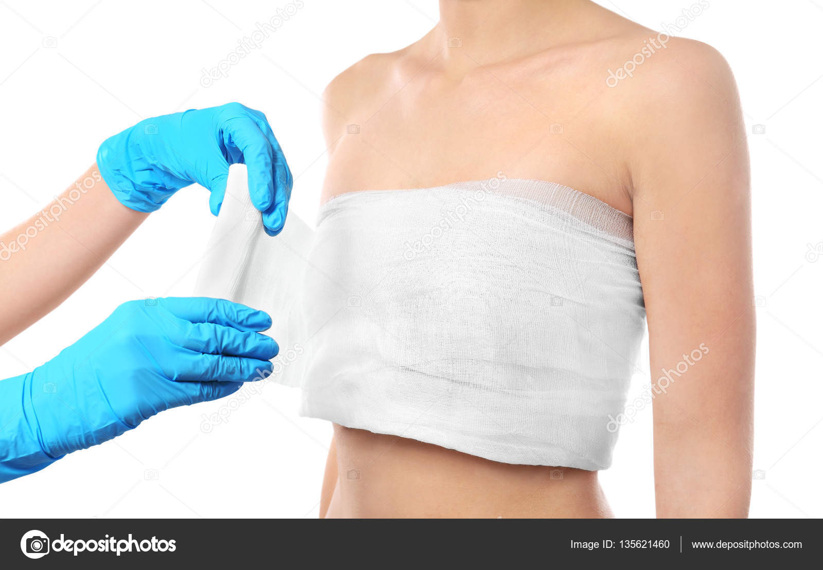 Doctor wrapping bandage around chest Stock Photo by ©belchonock
