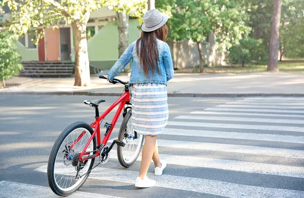 Woman with bicycle outdoors — Stock Photo, Image