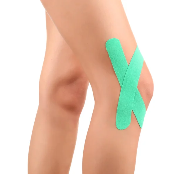 Female knee with physio tape — Stock Photo, Image