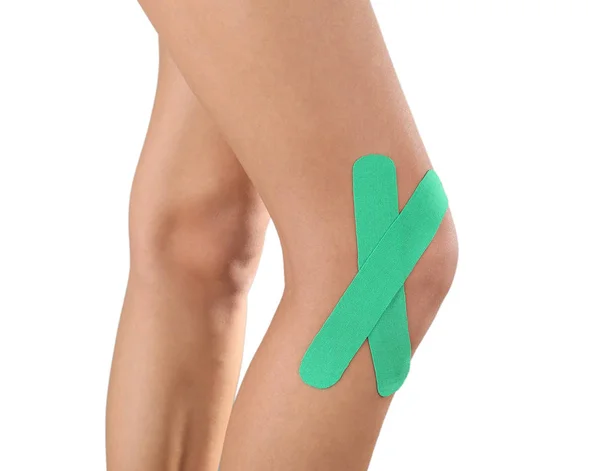 Female knee with physio tape — Stock Photo, Image