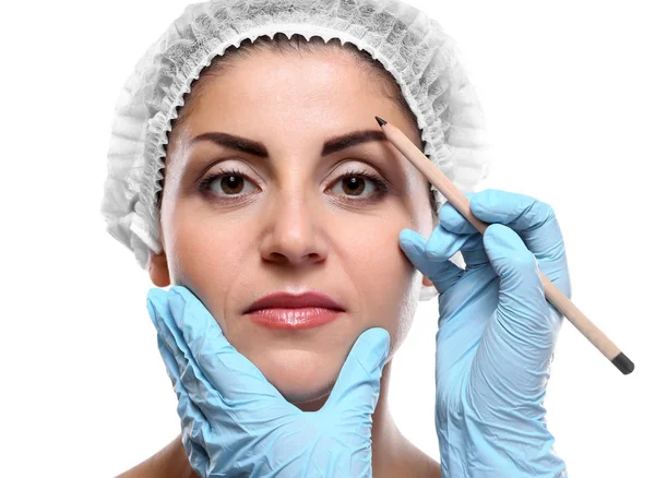 Surgeon examining female face — Stock Photo, Image