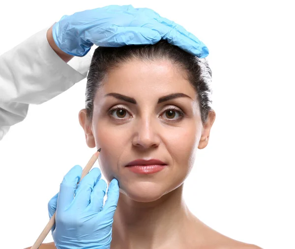 Surgeon hands examine female face — Stock Photo, Image