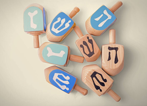 Wooden dreidels for Hanukkah on white background