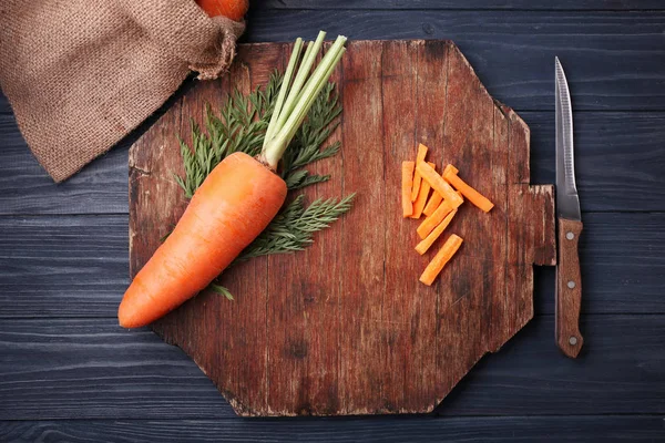 Fresh carrot on wooden cutting board — Stock Photo, Image