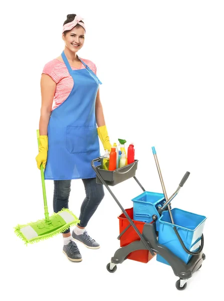 Young cleaner with cart and cleaning supplies on white background — Stock Photo, Image