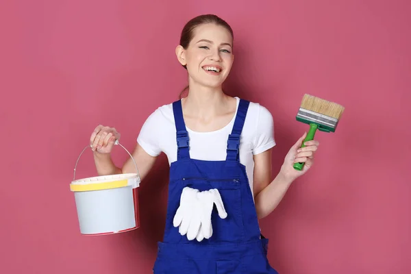 Beautiful young decorator on color background — Stock Photo, Image
